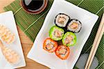 Sushi maki and shrimp sushi on wooden table