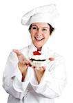 Pretty female pastry chef holding a delicious cheesecake tart topped with strawberry and chocolate.  Isolated on white.