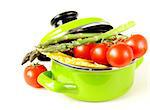 green pot full of vegetables (tomatoes, asparagus, mushrooms, broccoli) and pasta