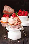 Sweet cupcakes with fresh raspberry and delicious cream.