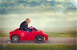 senior man enjoying driving a toy racing car