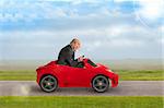 senior man in a suit driving a toy racing car