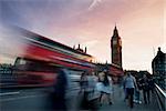 Slow motion blurred tourists and and traffic on Westminster Bridge with Big Ben in background, London.