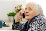 Close-up. Cute, elderly woman with mobile phone