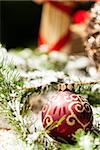 Christmas background with colourful shiny red and gold Xmas baubles with handcrafted straw ornaments and decorations tied with red ribbon for seasonal wishes