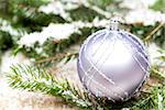 Silver Christmas ornaments in leaves with pine cones