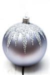 Glittery Christmas ornament ball on white background