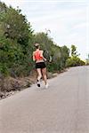 Fit young woman jogging or running outdoors