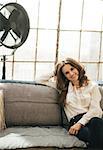 Portrait of happy young woman in loft apartment