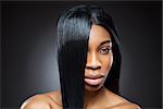 Beautiful young black woman with straight shiny hair