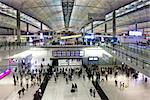 HONG KONG, CHINA - Passengers in the airport main lobby on Hong Kong, China.