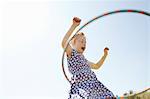 Low angle view of girl playing with plastic hoop