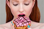 Young woman biting donut