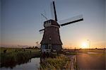Windmill and waterway at sunset, Vollendam, Netherlands
