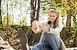 Young woman posing for self portrait in forest