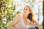 Portrait of young woman gazing calmly in forest