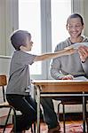 Father holding paper plane for son