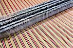 Close up of striped textile on weaving machine in woollen mill