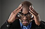 Portrait of stressed businessman with head in hands