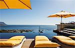 Lounge chairs overlooking infinity pool and ocean