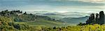 Early morning panoramic view of misty hills, near San Gimignano, Tuscany, Italy, Europe