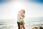 Romantic young couple hugging each other at coast