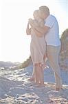 Mature couple hugging on beach