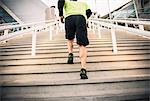 Cropped shot of mature male runner training on steps