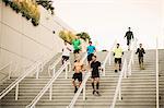 Small group of runners training on convention center stairs