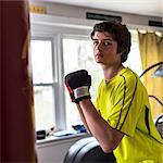 Teenage boy wearing boxing gloves