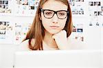 Young woman wearing glasses using computer