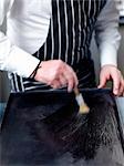 Buttering the baking tray