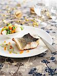 Bass fillet with herb sauce and spring vegetables