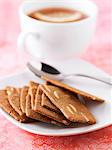 Cinnamon and thinly sliced almond cookies, a cup of coffee