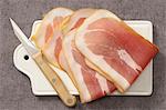 Slices of raw ham on a chopping board