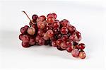 Bunch of red grapes on a white background