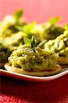 Blinis topped with minty cilantro zucchini puree