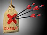 Disability - Three Arrows Hit in Red Mark Target on a Hanging Sack on Grey Background.