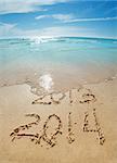 digits  2013 and 2014 on the sand seashore - concept of new year