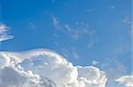 Puffy clouds and blue sky in sunny day