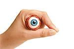 A person holds an eyeball in their hand.
