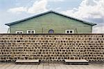 mauthausen,Austria-the prisoners' barracks and the wall with the barbed wire seen from inside the concentration camp of Mauthausen in Austria during a sunny day