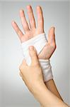 Injured painful hand with white bandage