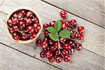 Ripe cherries on wooden table. View from above