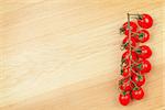 Cherry tomatoes on wooden table background with copy space