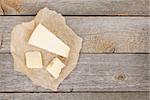 Parmesan cheese on wooden table background with copy space