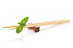 Sushi chopsticks with mint leaves. Isolated on white background