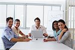 Attractive business people smiling at the camera during a business meeting