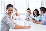 Attractive businesswoman smiling at the camera during a business meeting