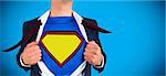 Businessman opening shirt in superhero style against blue background with vignette